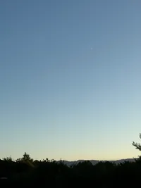Soft sky gradient and crescent moon before dusk